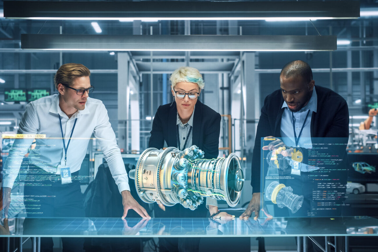 green energy car design: diverse team of automotive enginers using augmented reality hologram to construct 3d model of high tech electric engine turbine. futuristic automated robot arm manufacturing